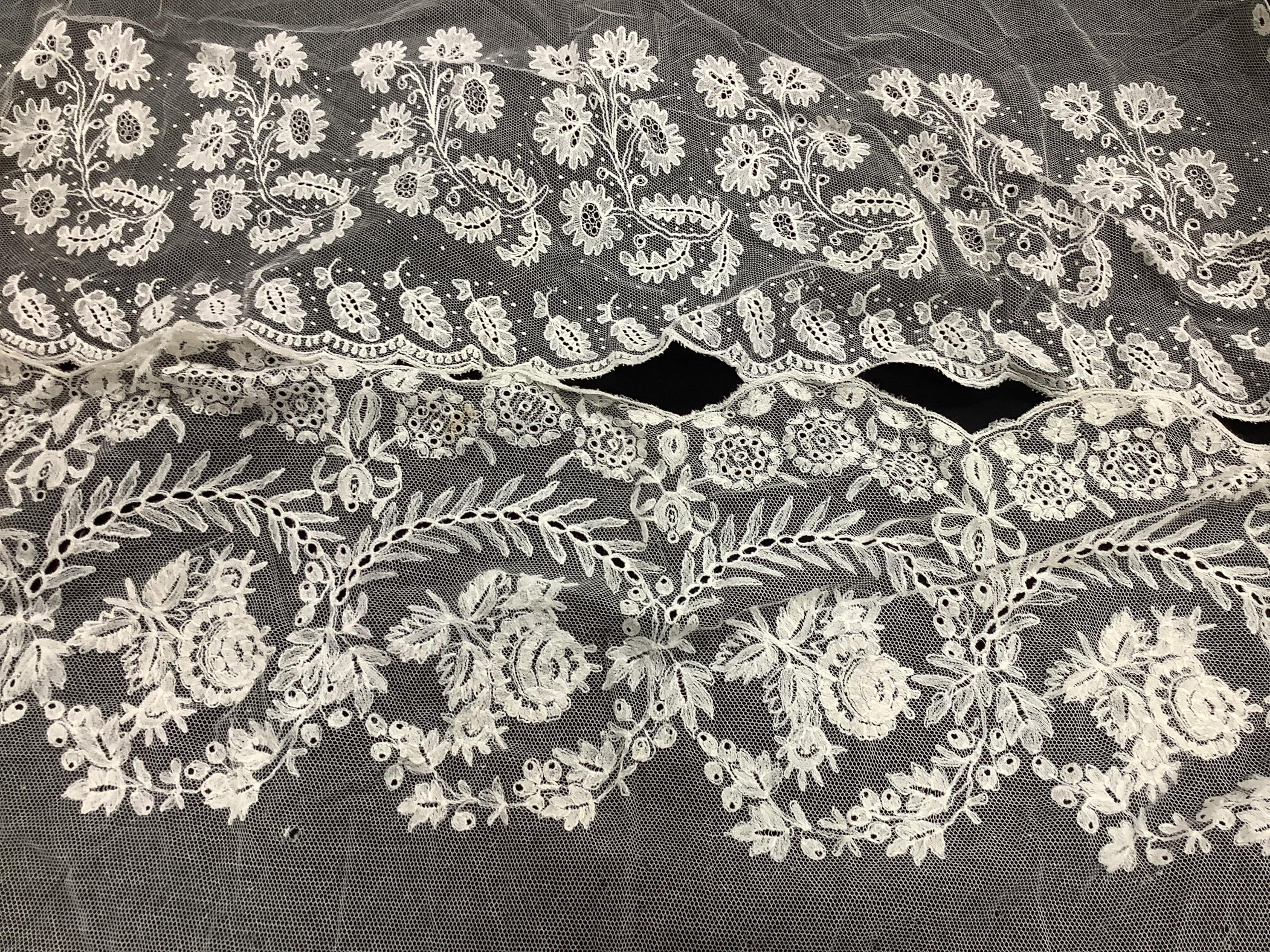 A small late 19th century Brussels wedding veil, an earlier Brussels bobbin bonnet veil, two needle run bonnet veils, various lace sleeves and a lilac silk and lace coverlet., Brussels veil 140cm x 132cm. Condition - the